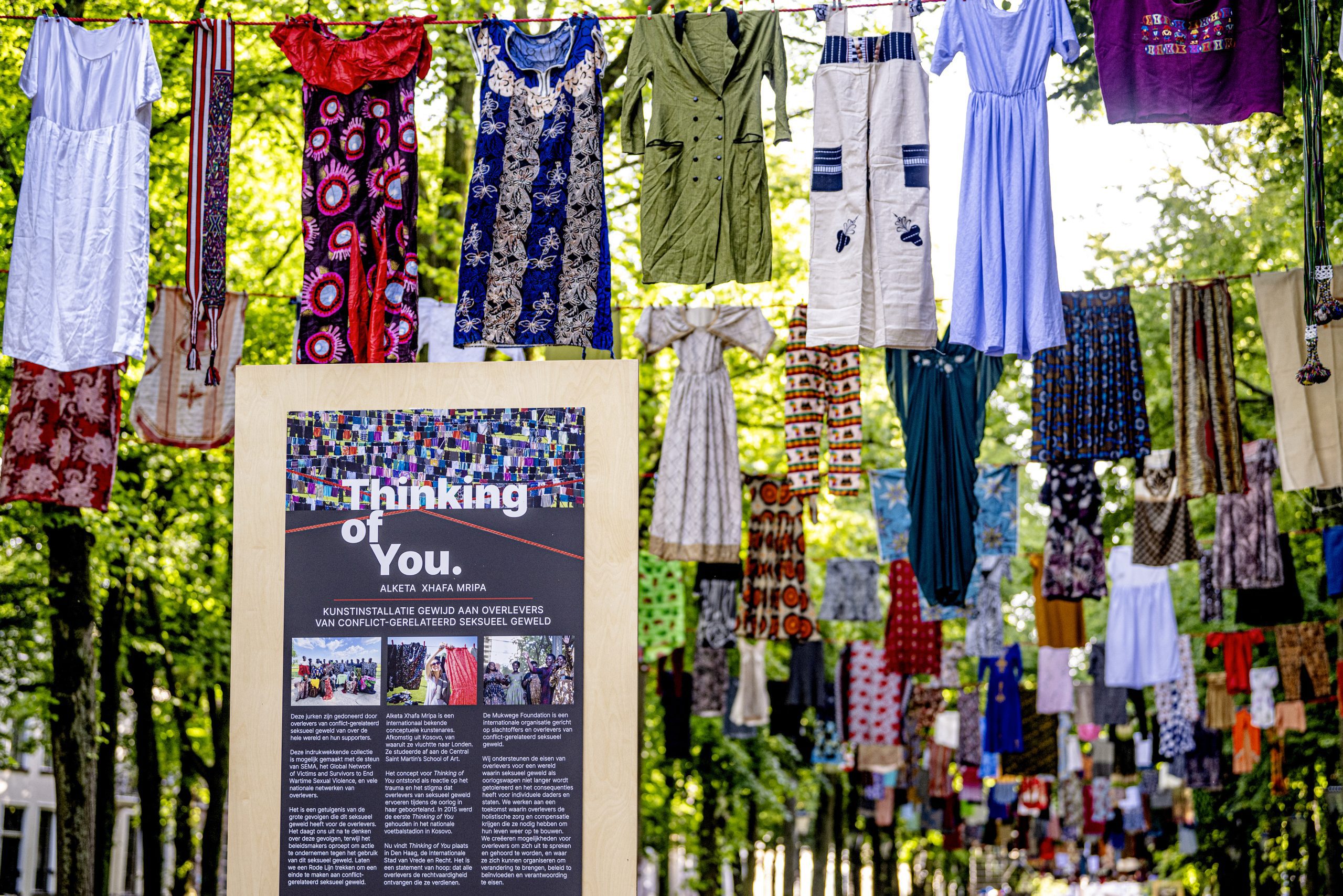 Board explaining Thinking of You with dresses in background.