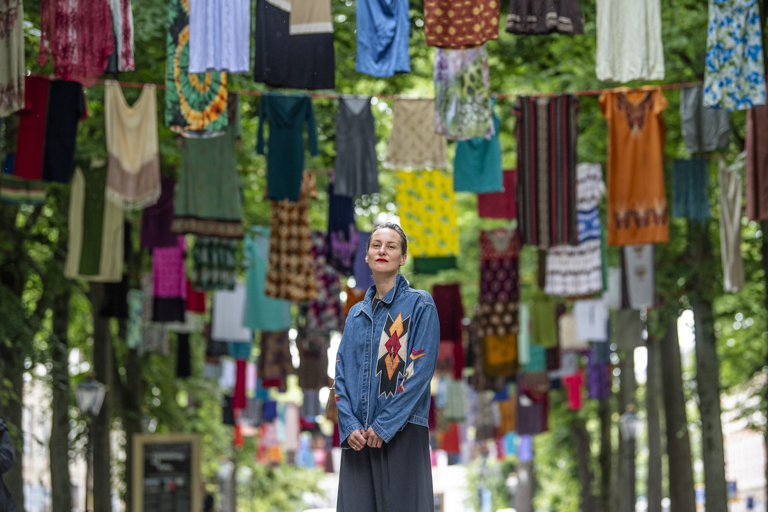 Artist Alketa Xhafa Mripa in front of the outdoor exhibition.