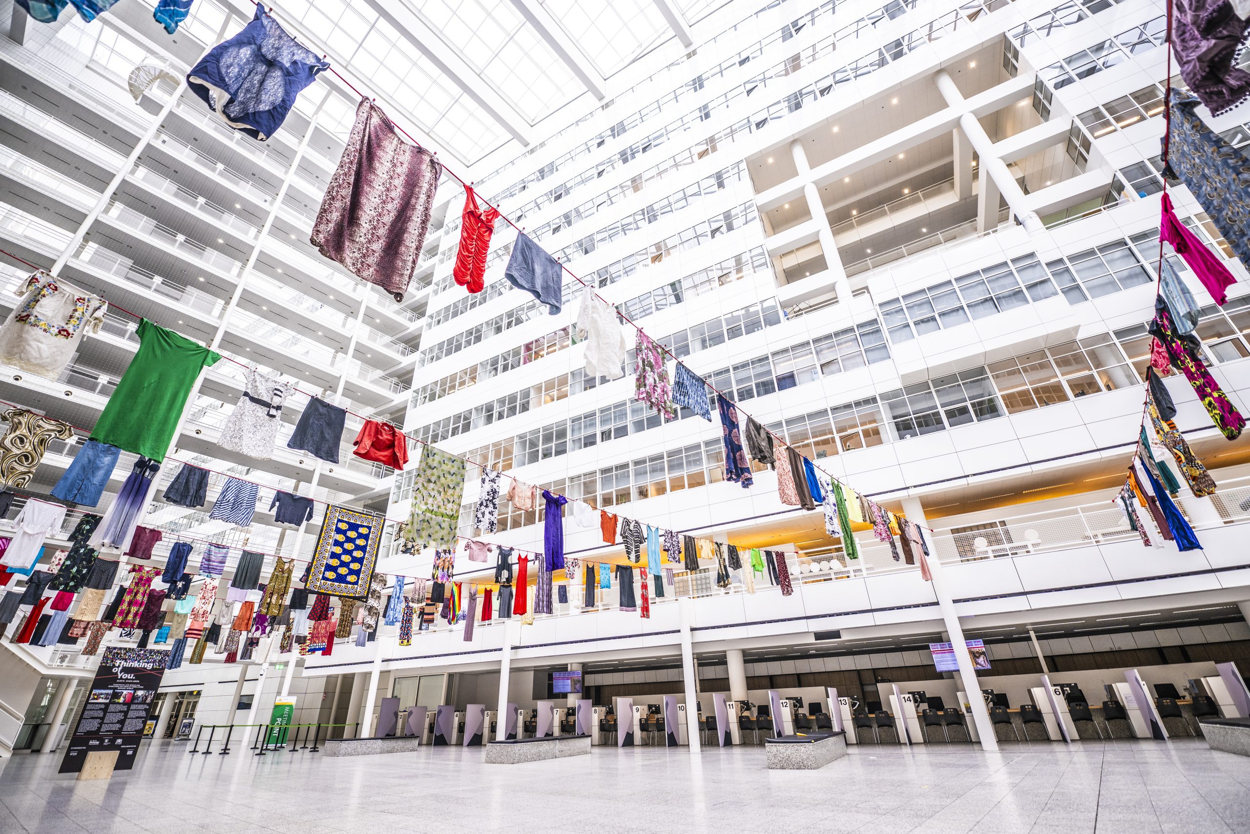 Hundreds of dresses hanging in the Atrium City Hall in The Hague.